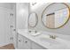 Bright bathroom featuring double vanity sinks with gold framed mirrors and modern fixtures at 2326 Marlow Dr, Burlington, NC 27215