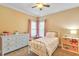 Bright bedroom features a ceiling fan and a window with light-filtering pink curtains at 2326 Marlow Dr, Burlington, NC 27215