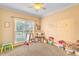 Bright bedroom with a large window, carpet, toys, and furniture at 2326 Marlow Dr, Burlington, NC 27215
