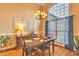 Inviting dining room featuring a chandelier, a large window, hardwood flooring, and elegant wall decor at 2326 Marlow Dr, Burlington, NC 27215