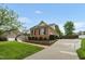 Brick home featuring a well-manicured lawn, landscaping, a driveway, and an attached garage at 2326 Marlow Dr, Burlington, NC 27215