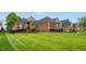 Beautiful brick home featuring a manicured lawn and lovely landscaping, creating great curb appeal at 2326 Marlow Dr, Burlington, NC 27215