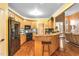 Well-equipped kitchen with wood cabinets, granite countertops, stainless steel appliances, and a breakfast bar at 2326 Marlow Dr, Burlington, NC 27215