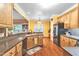 Bright kitchen with warm wood cabinets, stone countertops, and stainless steel refrigerator at 2326 Marlow Dr, Burlington, NC 27215