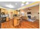 Open concept kitchen flowing into the living room, featuring wood cabinets and a breakfast bar at 2326 Marlow Dr, Burlington, NC 27215