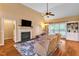 Spacious living room with a fireplace, hardwood floors, a ceiling fan, and comfortable seating at 2326 Marlow Dr, Burlington, NC 27215