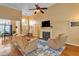 Bright living room featuring hardwood floors, a fireplace, and comfortable seating under a ceiling fan at 2326 Marlow Dr, Burlington, NC 27215