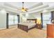Spacious main bedroom with tray ceiling, carpet, and large windows with wooded views at 2326 Marlow Dr, Burlington, NC 27215
