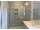 Bathroom featuring a frameless glass shower and single-sink vanity with a white countertop at 245 N Maple Walk Dr # 219, Garner, NC 27529