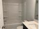 Bright bathroom with shower-tub, white tiling and single-sink vanity with a white countertop at 245 N Maple Walk Dr # 219, Garner, NC 27529