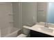 Bright bathroom with shower-tub, white tiling and single-sink vanity with a white countertop at 245 N Maple Walk Dr # 219, Garner, NC 27529