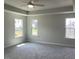 Bedroom featuring a ceiling fan and three windows, showcasing a neutral color palette at 245 N Maple Walk Dr # 219, Garner, NC 27529