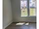 Bright room with hardwood floors and large windows overlooking the backyard at 245 N Maple Walk Dr # 219, Garner, NC 27529