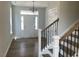 Home foyer features a white front door, light hardwood floors, and a staircase at 245 N Maple Walk Dr # 219, Garner, NC 27529