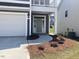 Home features a covered front entryway with gray siding and a light gray door at 245 N Maple Walk Dr # 219, Garner, NC 27529