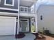 Home exterior with a balcony over the front entry, gray siding, and modern landscaping at 245 N Maple Walk Dr # 219, Garner, NC 27529