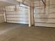 Spacious two car garage with a concrete floor and automatic doors at 245 N Maple Walk Dr # 219, Garner, NC 27529