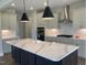 Modern kitchen features a spacious island, stainless steel appliances, and pendant lighting at 245 N Maple Walk Dr # 219, Garner, NC 27529