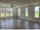 Spacious living room with hardwood floors, coffered ceilings, a modern fan, and large windows at 245 N Maple Walk Dr # 219, Garner, NC 27529