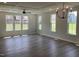 Open floor plan featuring hardwood floors, recessed lighting, a chandelier, and many windows at 245 N Maple Walk Dr # 219, Garner, NC 27529