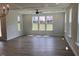 Bright living room featuring hardwood floors, white trim, a modern ceiling fan, and many windows at 245 N Maple Walk Dr # 219, Garner, NC 27529