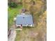Aerial view of the home with a well-maintained roof, spacious yard, and mature trees at 2721 Thelma St, Durham, NC 27704
