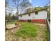 Fenced backyard with lush greenery, a small deck, and a shed at 2721 Thelma St, Durham, NC 27704