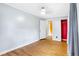 Bright bedroom showcasing hardwood floors, neutral walls, and an adjacent closet at 2721 Thelma St, Durham, NC 27704