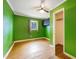 Bedroom with hardwood floors, closet and window with view of mature trees at 2721 Thelma St, Durham, NC 27704