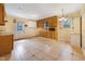 Spacious kitchen with tile flooring, wood cabinets, and a door to the backyard at 2721 Thelma St, Durham, NC 27704