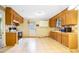 Bright kitchen with wood cabinets, white tile floors and a door leading outside at 2721 Thelma St, Durham, NC 27704