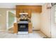 Kitchen with tile floors, wood cabinets, and black oven with range hood at 2721 Thelma St, Durham, NC 27704