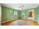 Green living room with hardwood floors, ceiling fan, and window with natural light at 2721 Thelma St, Durham, NC 27704