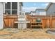 Outdoor cooking area with a built-in grill and green egg smoker, perfect for entertaining in the fenced yard at 282 Granite Mill Blvd, Chapel Hill, NC 27516