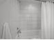 Close up shot of a tiled shower-tub combination with bright white tiles at 282 Granite Mill Blvd, Chapel Hill, NC 27516