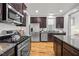 Bright kitchen boasts stainless steel appliances, granite countertops, and dark wood cabinetry at 282 Granite Mill Blvd, Chapel Hill, NC 27516