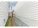 Narrow side yard between two houses, featuring gravel and stone landscaping for easy maintenance at 282 Granite Mill Blvd, Chapel Hill, NC 27516