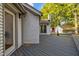 Spacious backyard deck with white brick exterior and view of detached garage at 3014 Hope Valley Rd, Durham, NC 27707