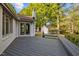 Large backyard deck with lush greenery and a detached white garage in background at 3014 Hope Valley Rd, Durham, NC 27707