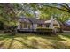 Picture showcasing the deck, a chimney, and mature shrubbery, that highlights the outdoor living space and property features at 3014 Hope Valley Rd, Durham, NC 27707