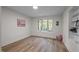 Well-lit bedroom with hardwood floors, a large window, and stylish decor at 3014 Hope Valley Rd, Durham, NC 27707