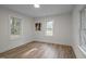 Cozy bedroom boasts hardwood floors, ample natural light, and new paint at 3014 Hope Valley Rd, Durham, NC 27707
