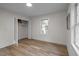 Bright bedroom with hardwood floors and a closet, featuring a charming window at 3014 Hope Valley Rd, Durham, NC 27707