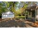 Exterior view of the home with detached garage and a well-maintained yard at 3014 Hope Valley Rd, Durham, NC 27707