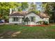 Charming single-story home with a well-manicured lawn, brick chimney, and inviting curb appeal at 3014 Hope Valley Rd, Durham, NC 27707