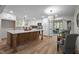 Bright, updated kitchen with white cabinets, a large island, stainless steel appliances, and wood floors at 3014 Hope Valley Rd, Durham, NC 27707