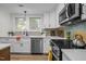 Updated kitchen featuring stainless steel appliances, white cabinetry, and modern fixtures at 3014 Hope Valley Rd, Durham, NC 27707