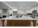 Bright kitchen boasts a large island, white cabinets, stainless appliances, and a decorative tile backsplash at 3014 Hope Valley Rd, Durham, NC 27707