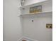 Functional laundry area with shelving and outlets, ready for washer and dryer hookups at 3014 Hope Valley Rd, Durham, NC 27707