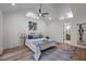 Main bedroom features high ceilings, skylights, accent wall art, and access to bath at 3014 Hope Valley Rd, Durham, NC 27707